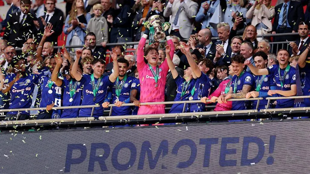 Oli Whatmuff celebrates making a key save during the penalty shootout