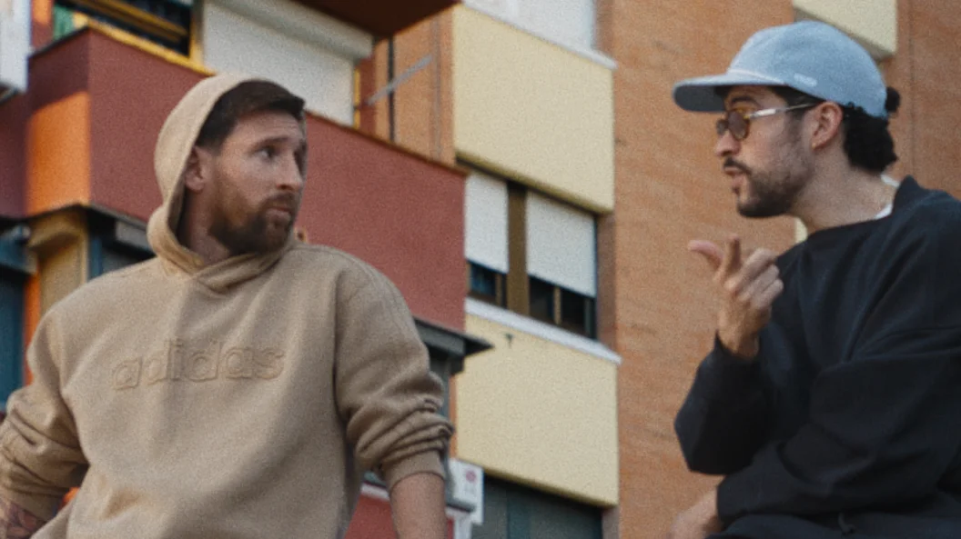 Lionel Messi and musician Bad Bunny are sitting on a car roof
